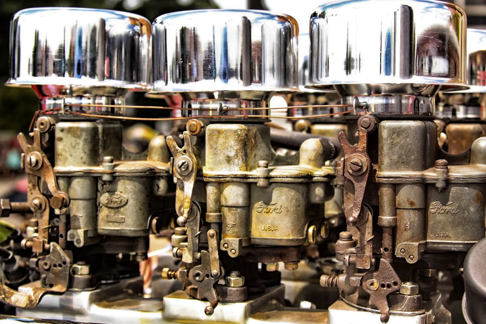 Detailed view of vintage Ford engine components with chrome accents at a car show in Marshfield, Wisconsin.